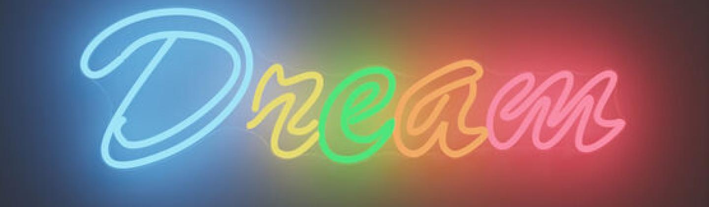 Neon light artwork. Colourful, spelling 'Dream' in neon lettering.