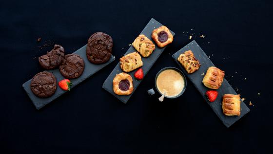 Biscuits and pastries on black serving boards