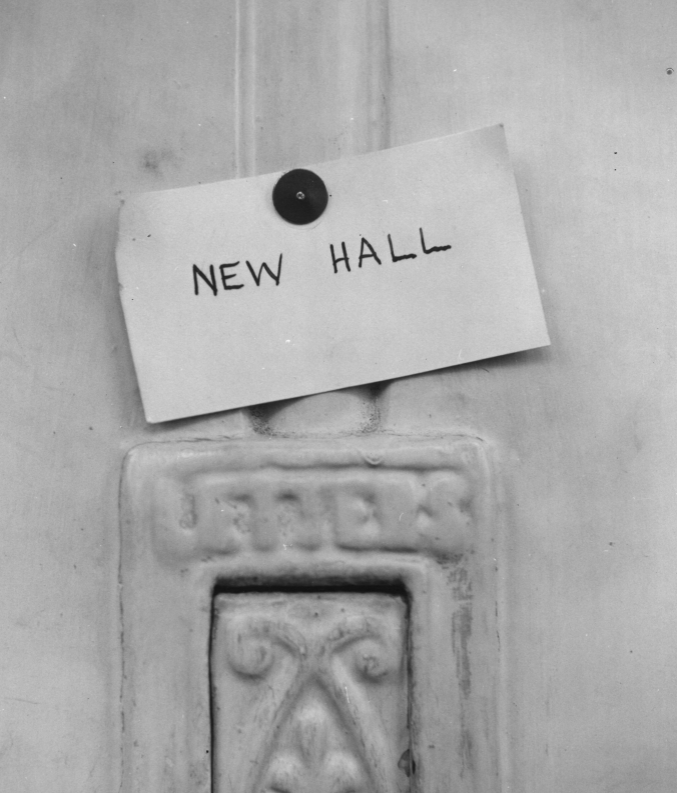 Note saying 'New Hall' pinning to an old door